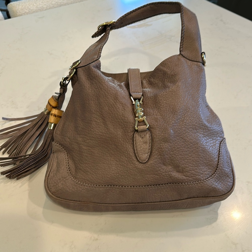 Gucci Tan with Gold Hardware. Leather and Bamboo/leather tassels.